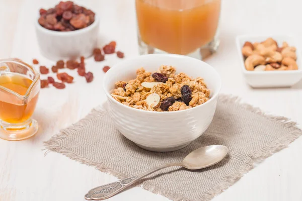 Granola, honey, nuts and raisins — Stock Photo, Image