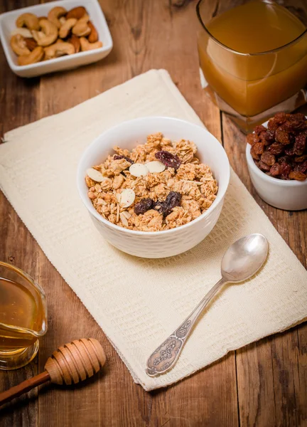 Granola, honey, nuts and raisins — Stock Photo, Image