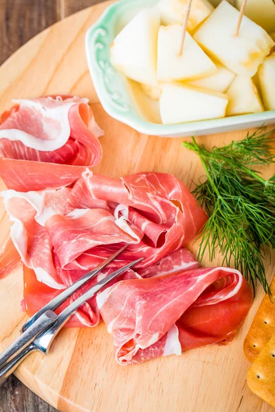 Italian food with melon and prosciutto — Stock Photo, Image