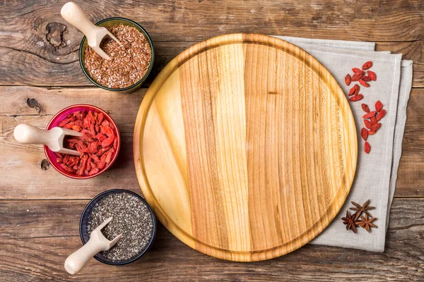 Seeds and goji in a wooden spoons — Stock Photo, Image