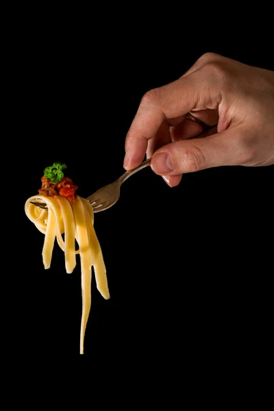 Mans hand holding a fork with pasta — Stock Photo, Image