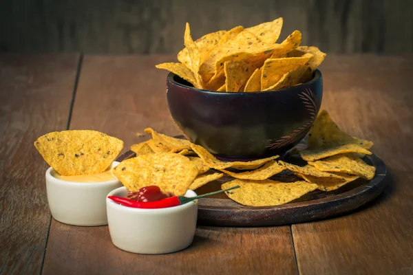 Mexican nacho chips and cheese and salsa dip in bowl — Stock Photo, Image