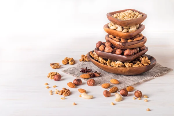 Almonds, walnuts, hazelnuts cashews and pine nuts in wooden bowl — Stock Photo, Image