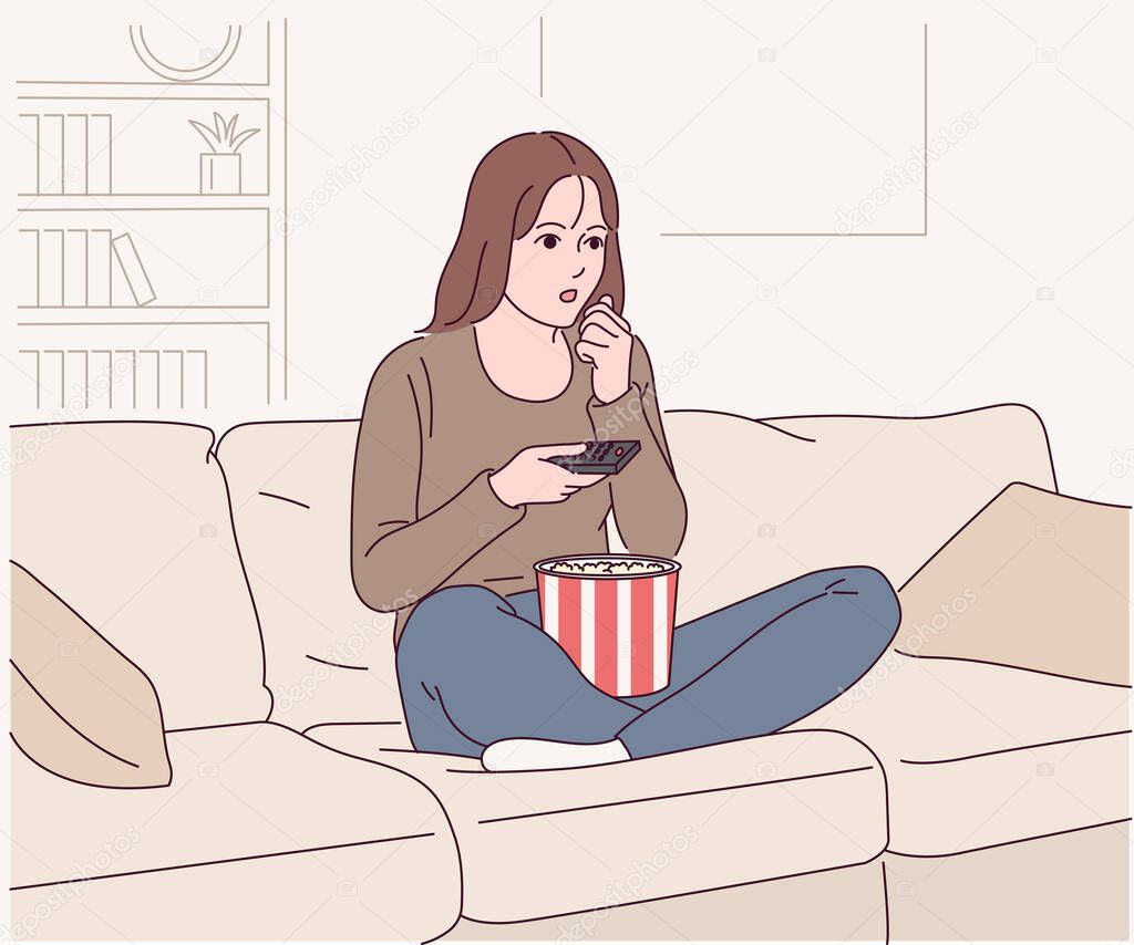 young woman watching tv at home.