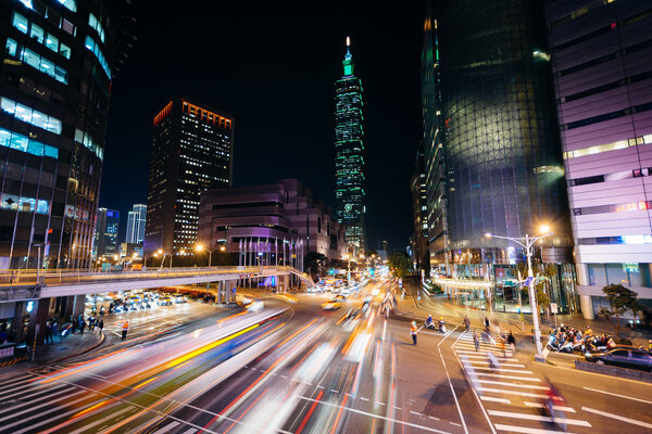 Traffic on Xinyi Road and view of Taipei 101 at night, in Taipei