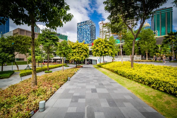 Sétány a parkban, és felhőkarcolók Bonifacio Global City, t — Stock Fotó
