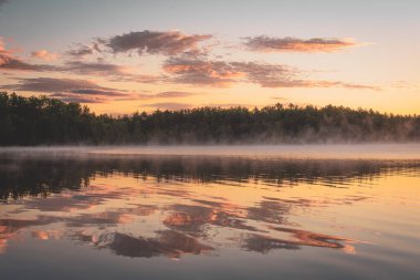 Fog on a lake at sunrise, at Baxter State Park, Maine clipart