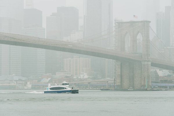 A ferry with the Brooklyn Bridge and Manhattan skyline in the background, from Dumbo, Brooklyn, New York City