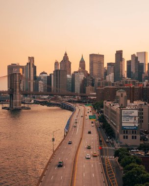 View of the East River, FDR Drive and skyline of the Financial District from the Manhattan Bridge, in the Lower East Side, New York City clipart