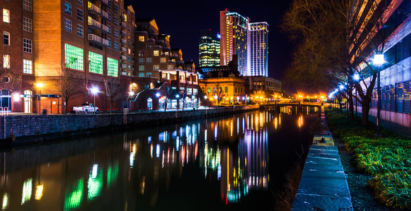 Buildings reflecting in the water at night in the Inner Harbor o