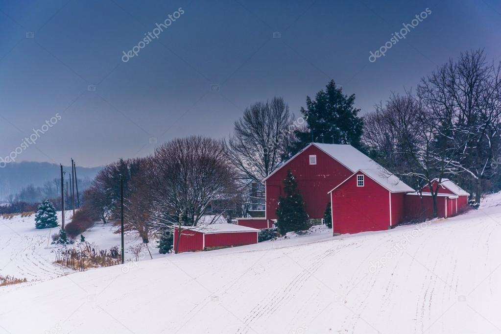Barn on snow covered farm fields in rural York County, Pennsylva