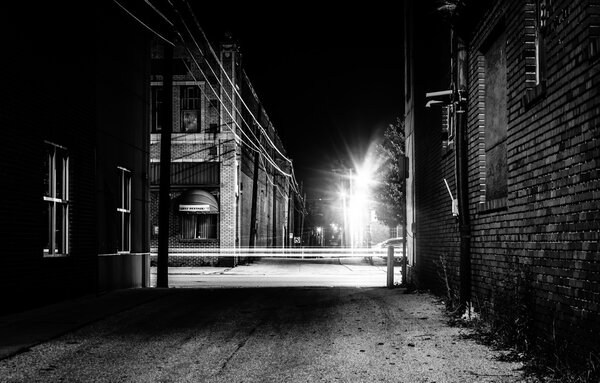 Dark alley and light trails in Hanover, Pennsylvania at night. 