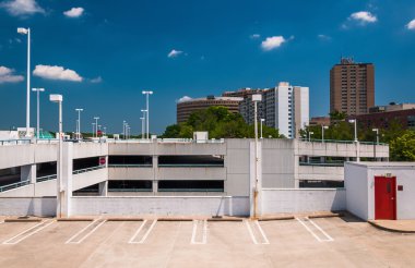 Parking garage and highrises in Towson, Maryland.  clipart