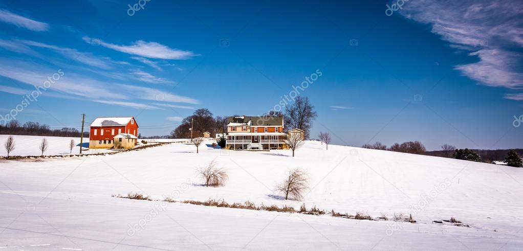 House and barn on snow covered farm fields in rural Carroll Coun