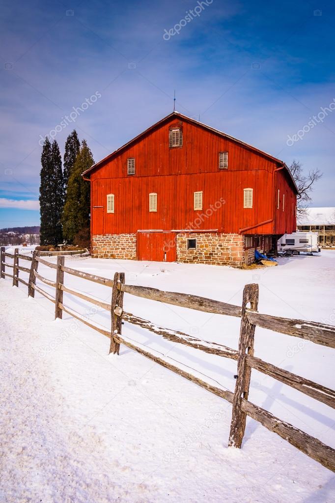 Red barn and fence in a snow-covered farm field in rural Adams C