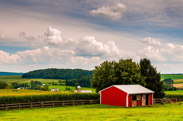 Small red stable and view of farms in Southern York County, Penn