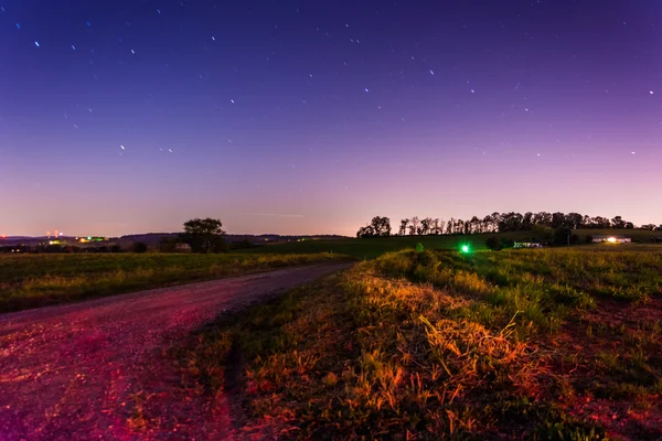 Startrails over a country road at night, in rural York County, P — Stock Photo, Image