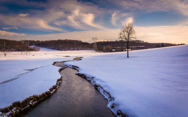 Stream through a snow covered farm field in rural Carroll County — Stock Photo, Image