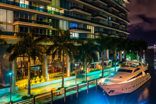 The Epic Hotel and a boat in the Miami River at night, in downto