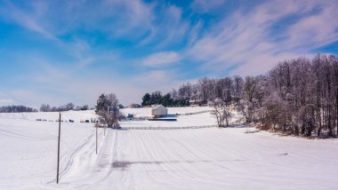 Winter view of snow covered farm fields in rural Carroll County, clipart