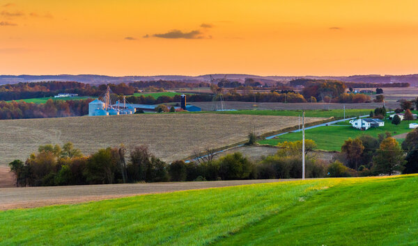 View of rolling hills and farm fields at sunset in rural York Co