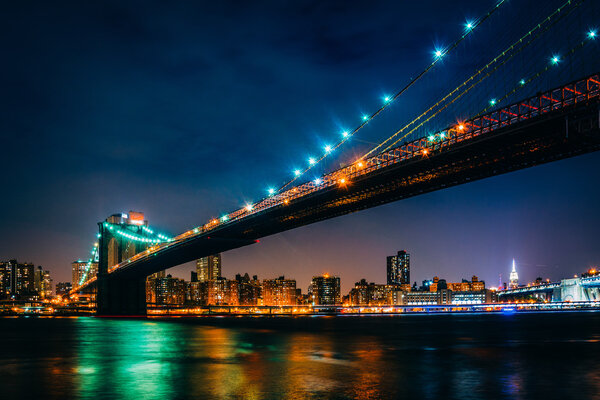 The Brooklyn Bridge at night seen from Brooklyn Bridge Park, New York.