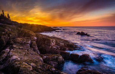 Sunrise over rocky coast and the Atlantic Ocean at Acadia Nation clipart