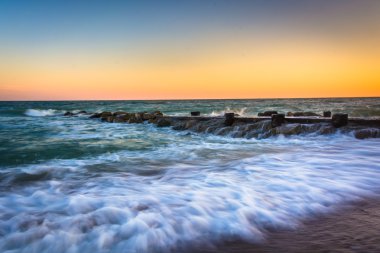 Dalgalar ve günbatımı bir iskeleye Edisto Beac, Atlantik Okyanusu