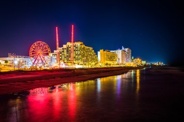 View of hotels and rides along the boardwalk at night from the f clipart