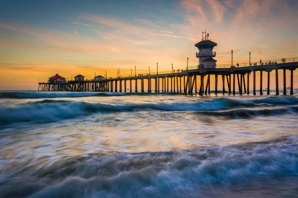 Golven in de Stille Oceaan en de pier bij zonsondergang, in Huntington — Stockfoto