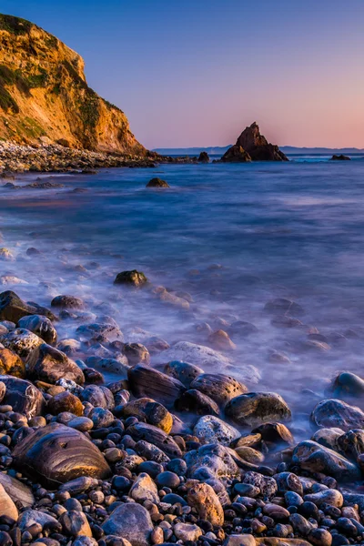 Long exposure of waves crashing on rocks at sunset, taken at Pel — Stock Photo, Image