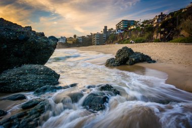 Rocks and waves in the Pacific Ocean at sunset, at Thousand Step clipart