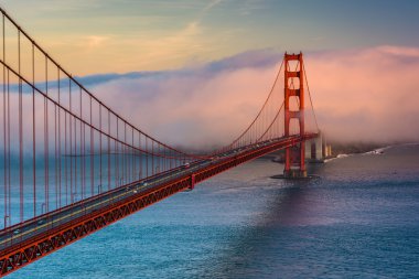 Sunset view of the Golden Gate Bridge and fog from Battery Spenc clipart