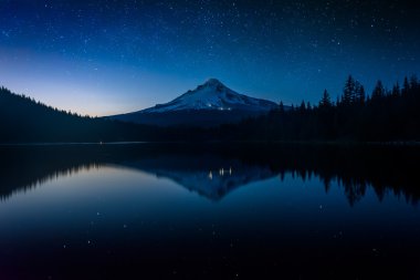 Stars in the night sky and Mount Hood reflecting in Trillium Lak clipart