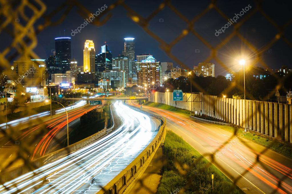 Chain link fence and view of I35 and the skyline at night, seen Stock