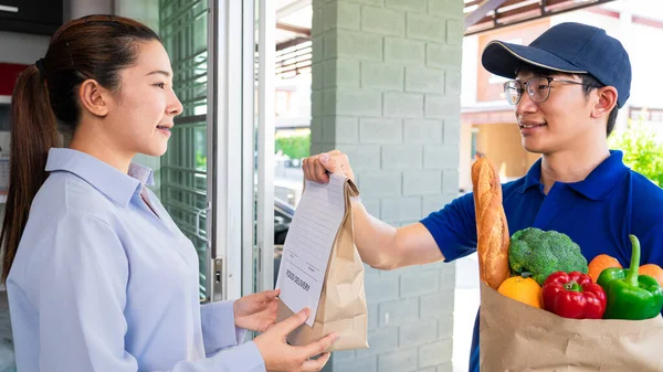 Kapıdaki Müşteriye Yiyecek Sebze Dolu Çanta Taşıyan Asyalı Teslimatçı Yemek — Stok fotoğraf