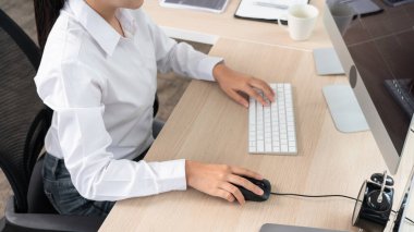 Genç Asyalı kadın programcı daktilo kodu masadaki bilgisayarla çalışıyor, siber uzay ve web geliştirme kavramını kodluyor.