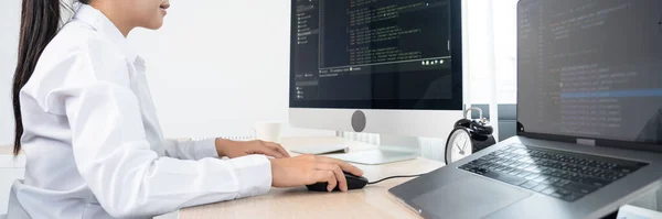 Asian Woman programmer typing source codes Programming On Computer in office, freelance web developer concept