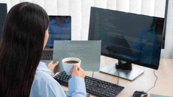 Asian woman programmer typing source code with computer pc for Developing program or application in her office