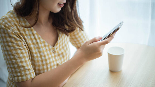 Entrepreneur concept a young female freelancer enjoying break time with social media on the device.