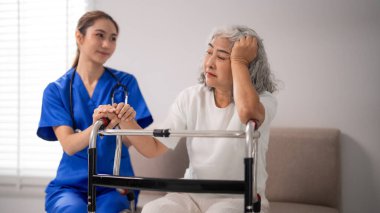 Asyalı kadın sağlık uzmanları, evdeki zorlu sağlık yolculuğu sırasında Walker 'ın empatik yardım önerdiği yaşlı bir hastayı rahatlatıyor.