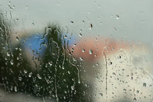 Concept of rainy and sad weather, depression and apathy. Raindrops on glass.