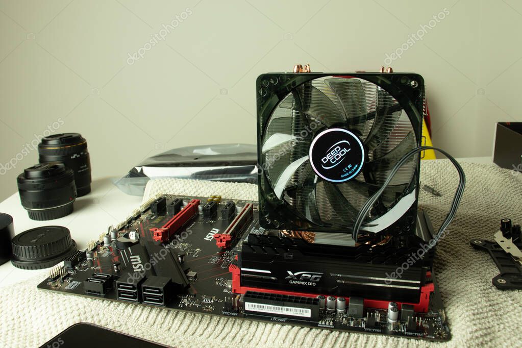 Moscow, Russia - 5 December 2020: PC MSI motherboard with CPU fan and RAM memory bars. Assembling the computer yourself, Illustrative Editorial.