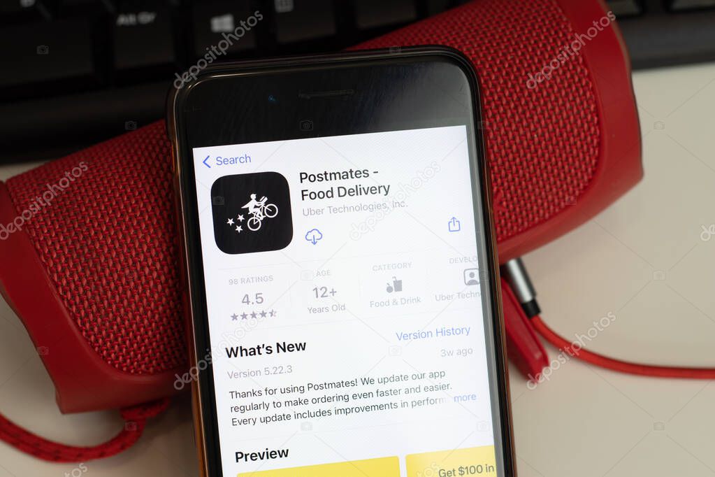 New York, USA - 26 April 2021: Postmates Food Delivery mobile app logo, phone with icon, Illustrative Editorial