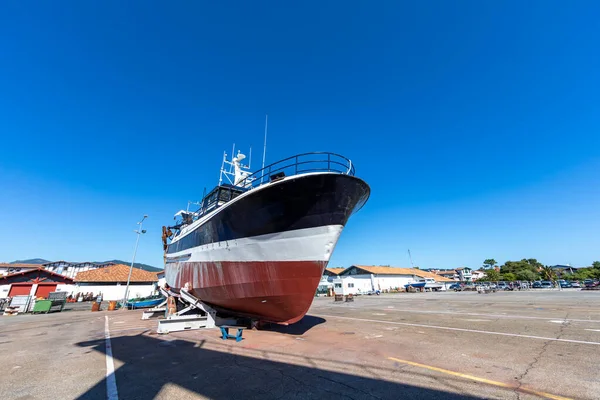 Old fishing boat dry-docked in Hendaye Harbour - Hendaye, Basque Country, France