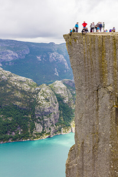Tourists hiking at the Preikestolen cliff in lysefjorden Norway