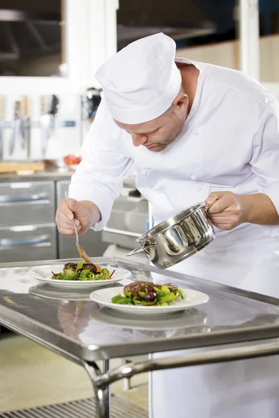 Professional chef prepare meat dish at restaurant — Stock Photo, Image