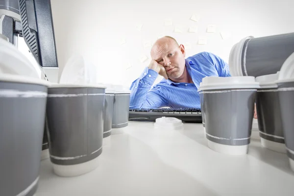 Overworked and bored businessman at office — Stock Photo, Image