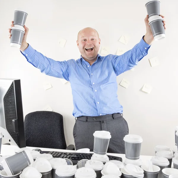 Happy and coffee addicted businessman at office — Stock Photo, Image