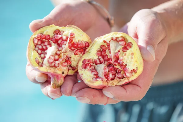 Divided organic pomegranate from the tree — Stock Photo, Image